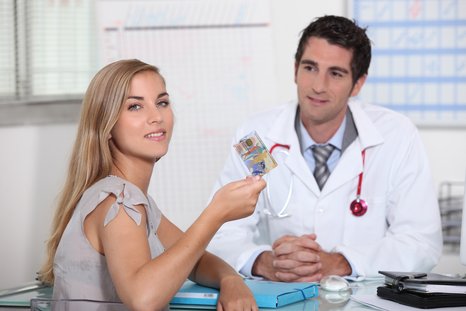 A symbolic image of a patient showing her health insurance card and a doctor observing her in the background